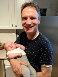 Michael Jansen holding a baby