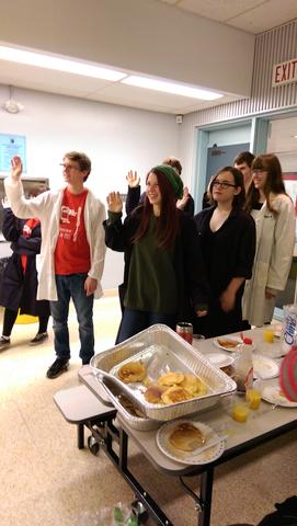 Students of Arnprior High School from Arnprior Ontario raising their hands to make the mole pledge at Mole Day Breakfast 