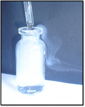 Dropper and white vapour exiting a bottle.