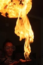 Student with a flame on her hand.