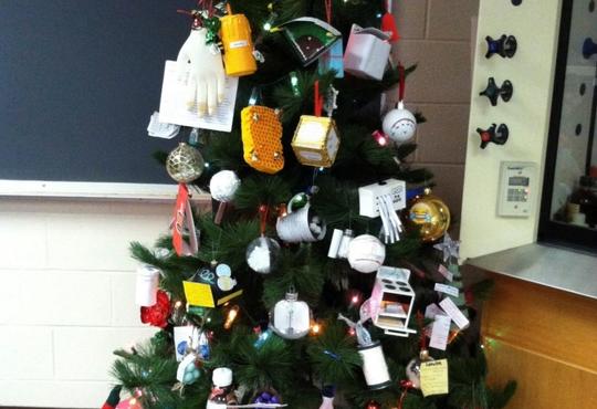 Christmas tree decorated with chemistry lab items.