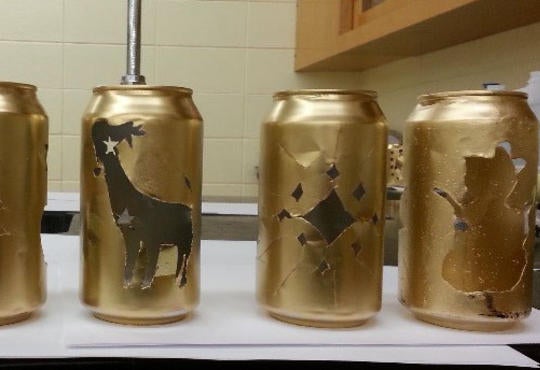 gold cans with cutouts