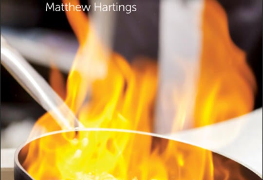 Chemistry in Kitchen book cover with a frying pan with a large flame in it