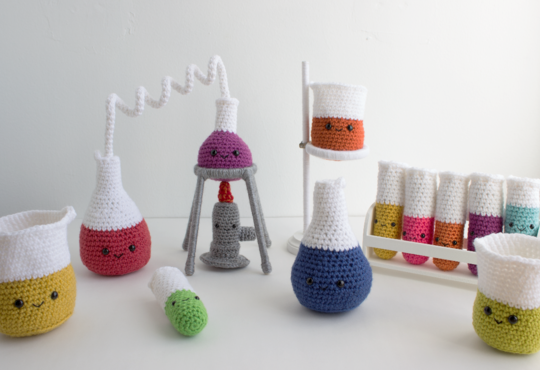 Crocheted beakers, test tubes and Bunsen burner.