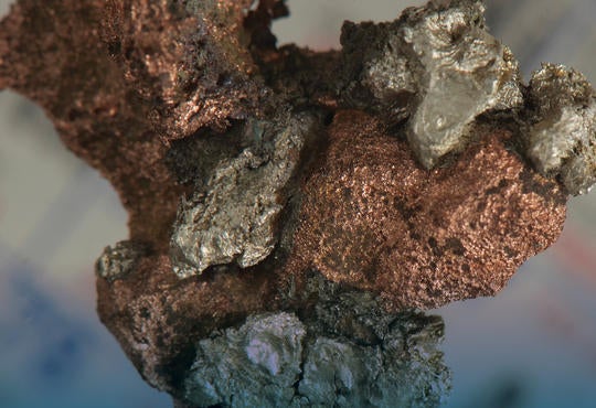 A closeup of a silver and copper nugget