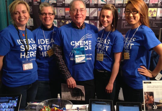 Six exhibit hall workers -- all dress in blue-- at the University of Waterloo booth at STAO 
