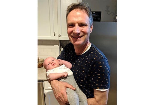 Michael Jansen holding a baby