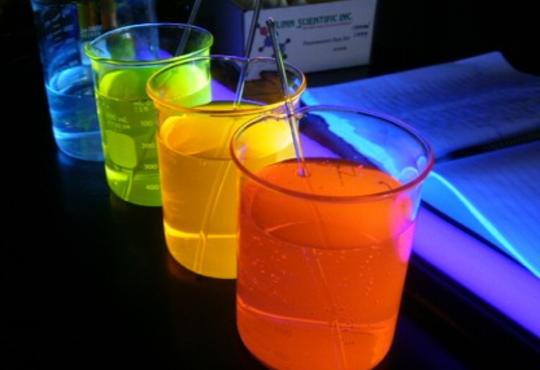 Beakers holding various coloured liquids.