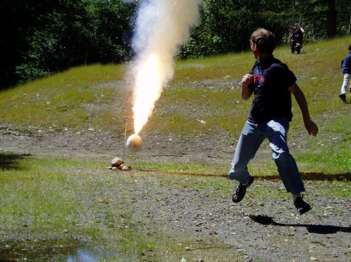 Boy running from thermite combustion.