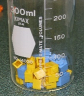 Lego pieces in a beaker.