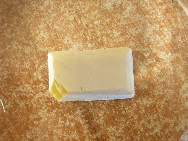 Block of white phosphorus with a sliced-off corner.
