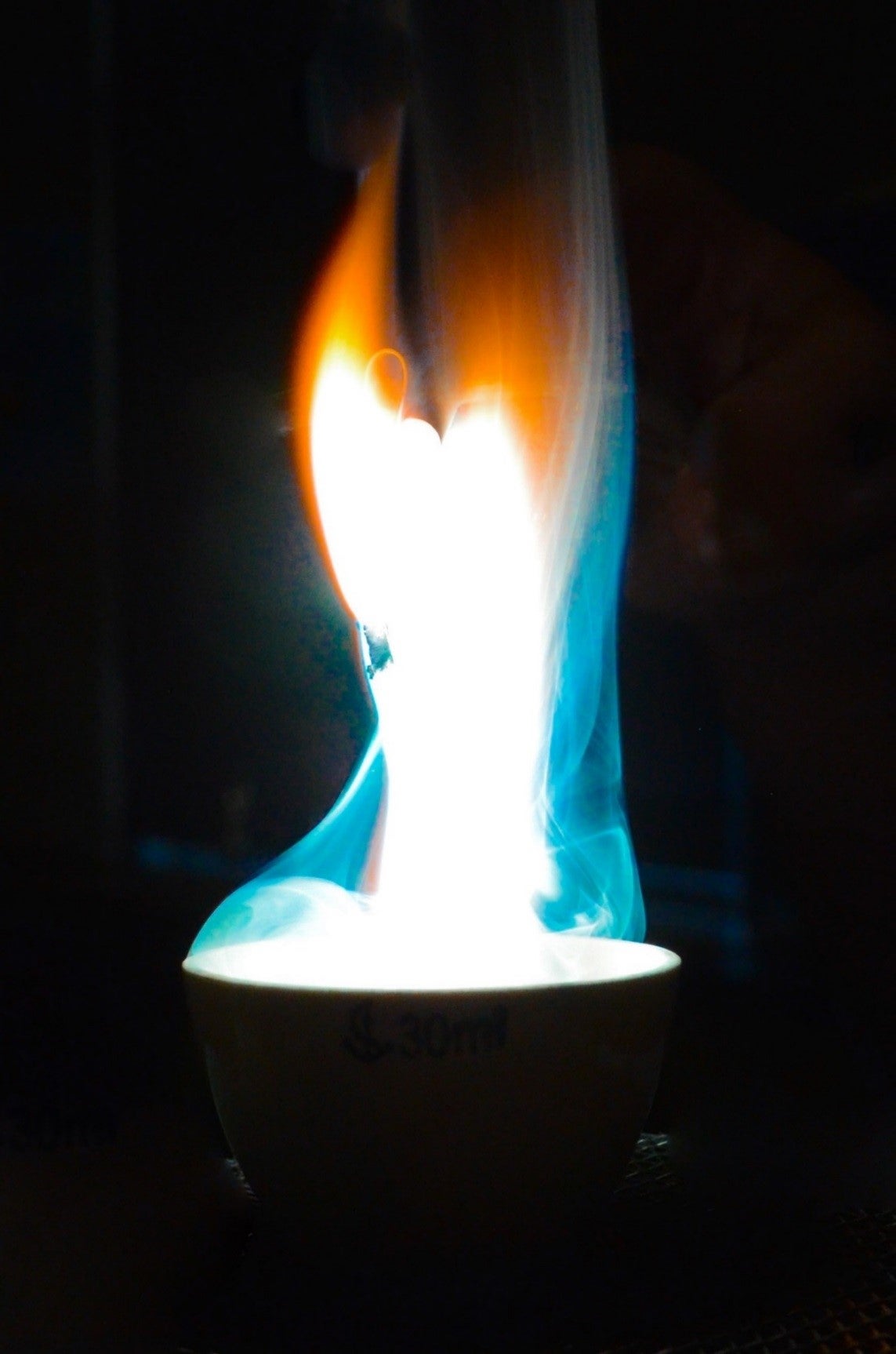 Blue, orange and white flames in a bowl.