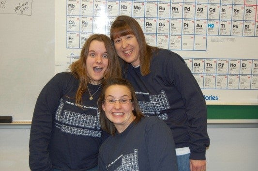 Jeannette Gobolos with her students, Britney Anderson and Ellis Smith and their blue custom-made periodic table shirts.