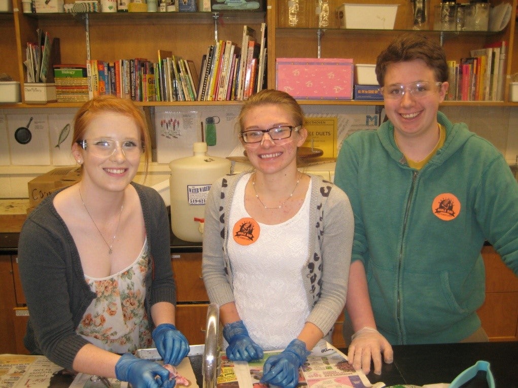 Three Science Club members smiling.