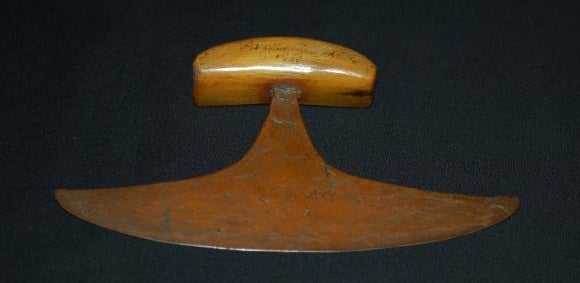 a semicircular copper blade and a bone handle -- ulu