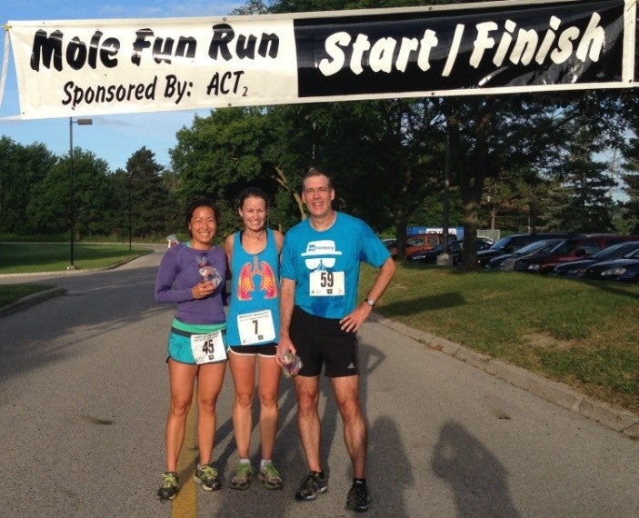 Two women and one man at the finish line of a ‘Mole Fun Run’.