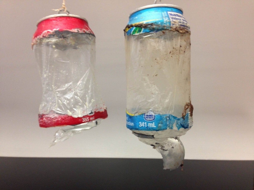 Soda cans corroded to have translucent plastic middles.