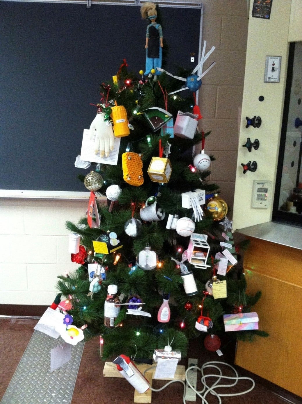 Christmas tree decorated with chemistry lab items.