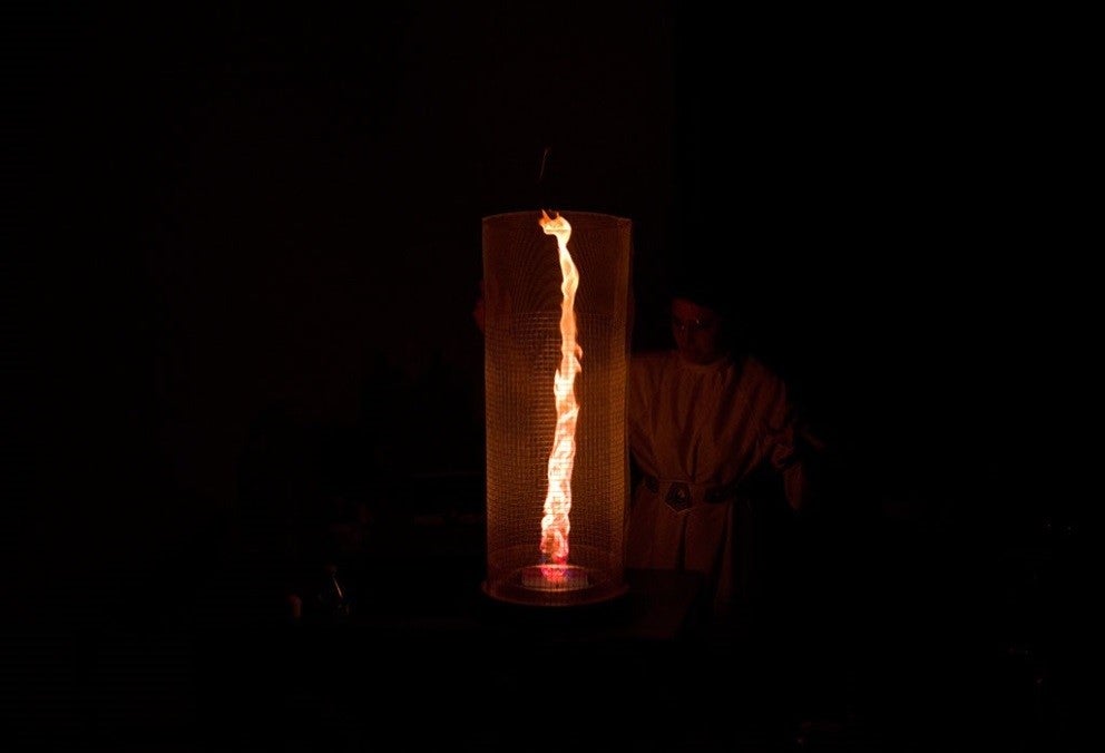 A flame tornado demonstration in a round wire cylinder.