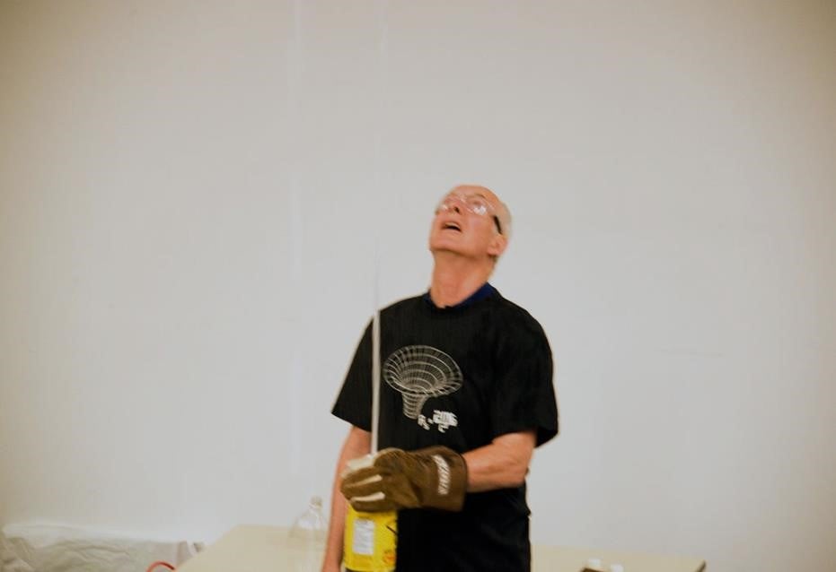 Doug De La Matter demonstrating how Mentos can cause soda pop to shoot out of a 2-L bottle.