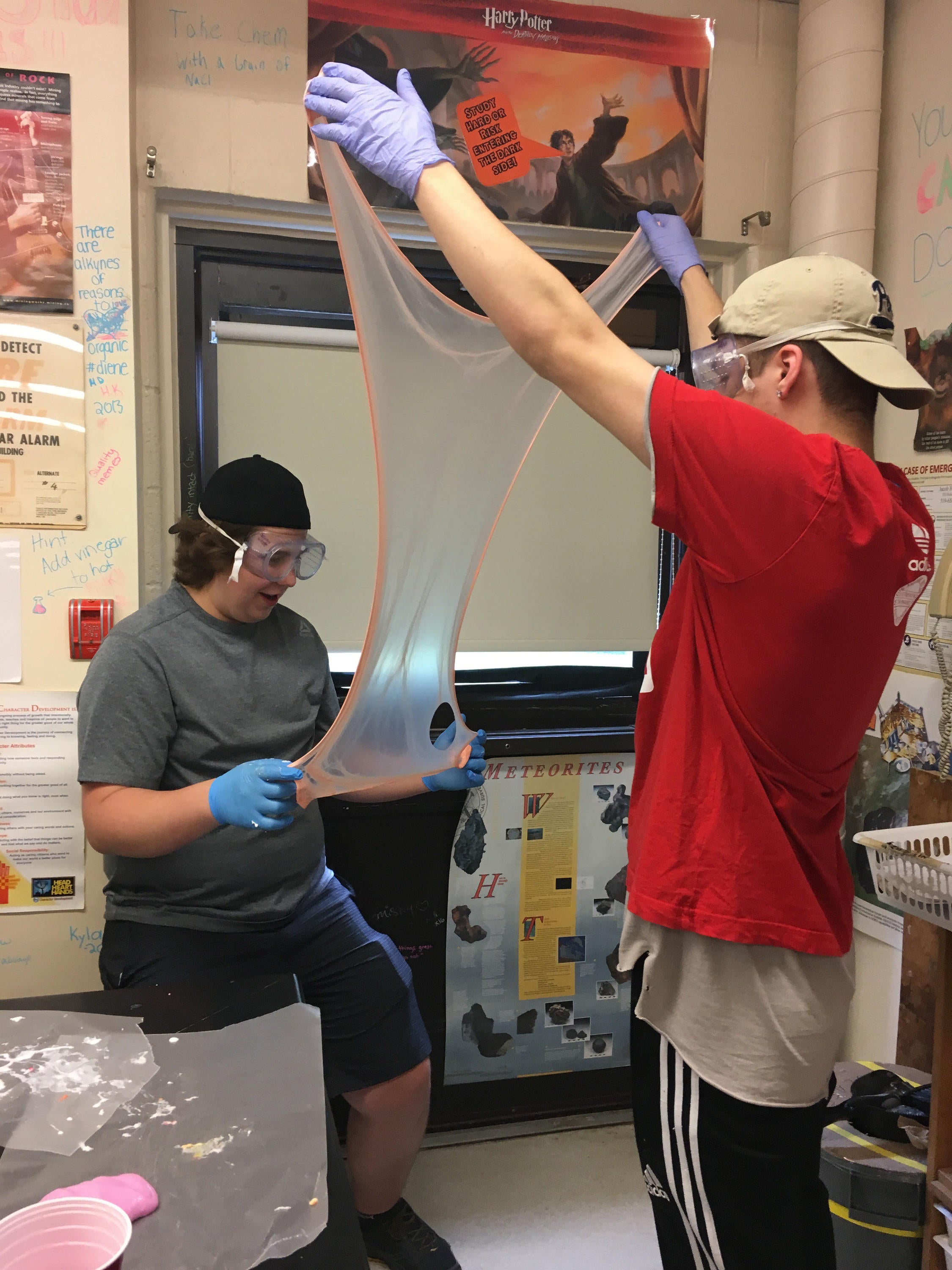 front cover of October 2018 issue with two students stretching out pink slime 