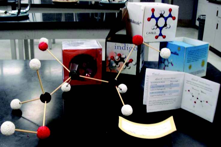 boxes and a molecule -- the boxes are all decorated with molecules - also a little booklet so it looks like a &quot;pet rock&quot; box except it is for molecules 