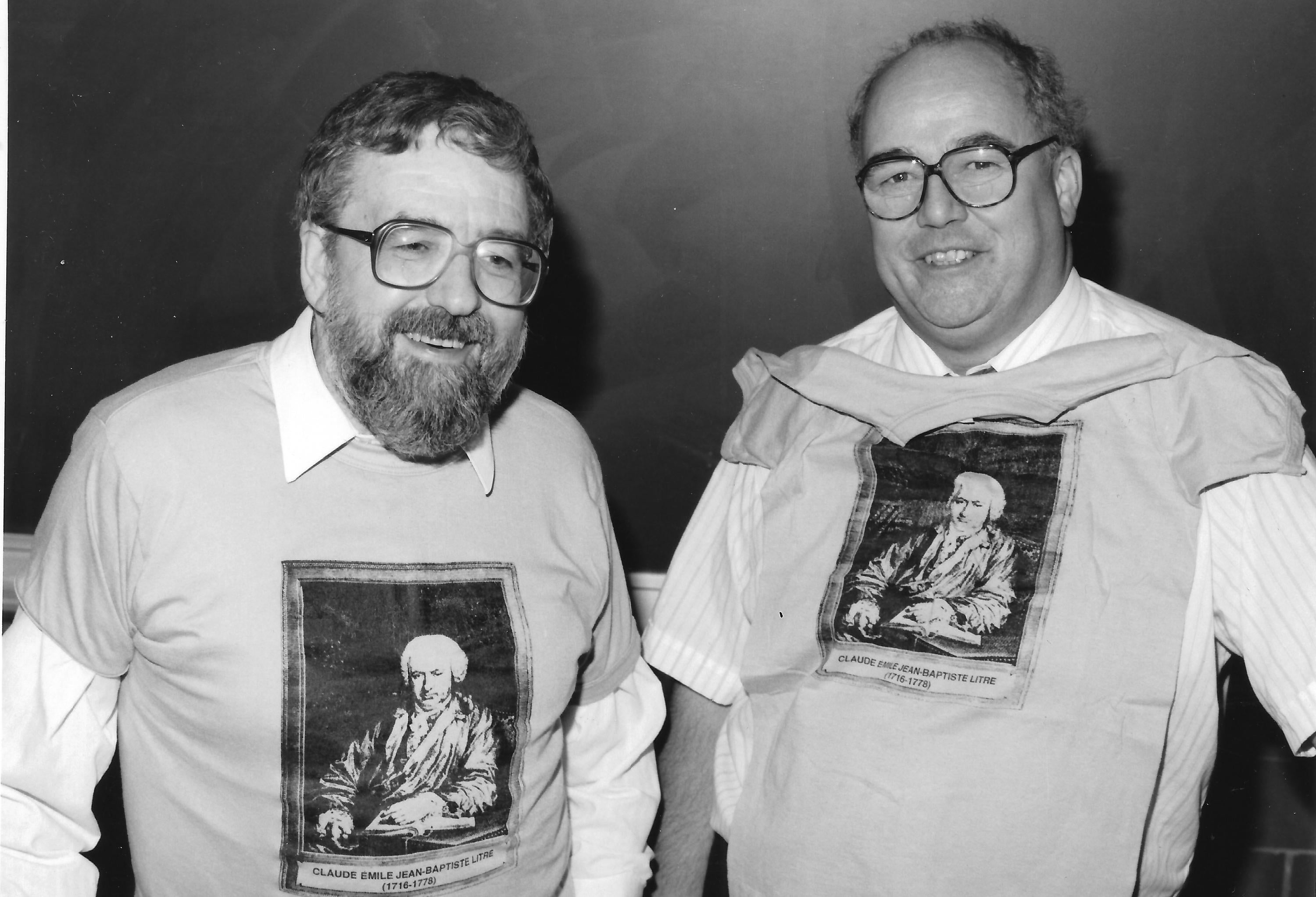 1989 photo of Ken Woolner and Reg Friesen each in T-shirt with a photo of fictional Litre