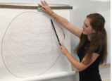 studying pointing at a drawing of an atom