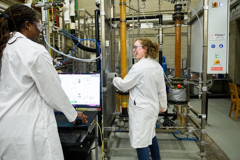 two women in front of equipment