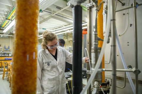 a woman standing of front of equipment