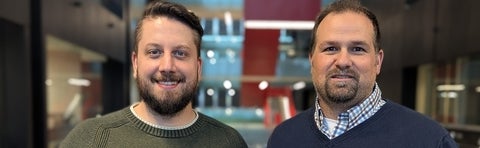 Two men with beards smiling