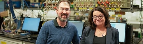 Dr. Michael Pope and Dr. Linda Nazar in front of battery testers