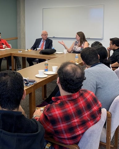 Dr. Gregory Stephanopoulos and Dr. Valerie Ward talking to grad students