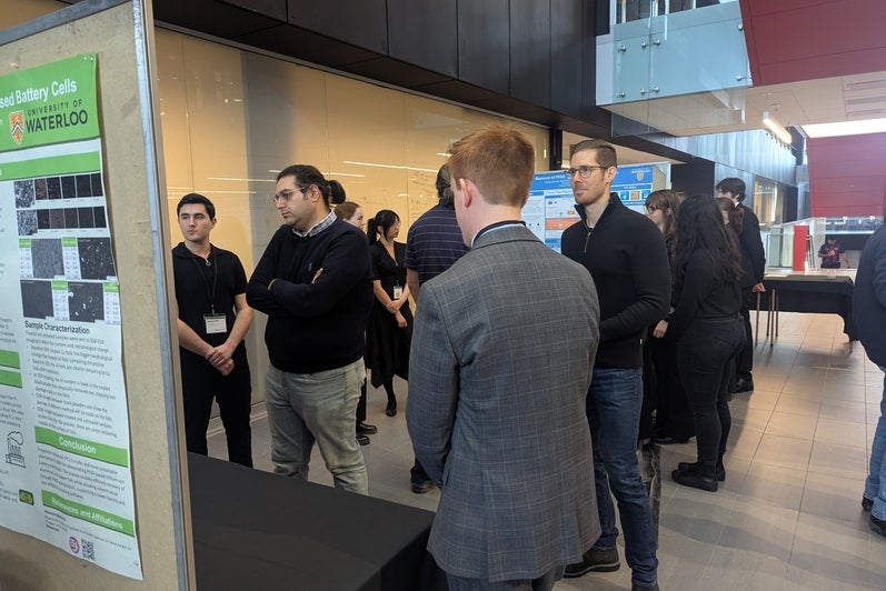 men standing around a poster board