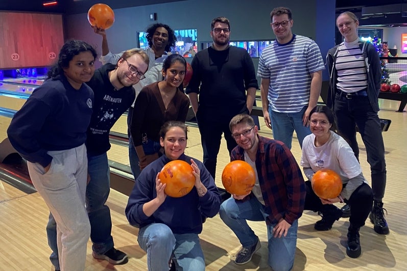 people posing with bowling balls