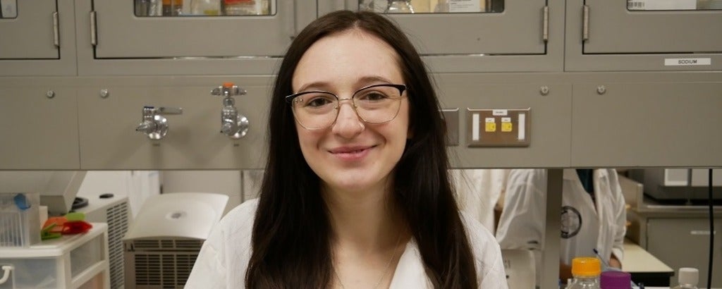 a woman in glasses smiling 