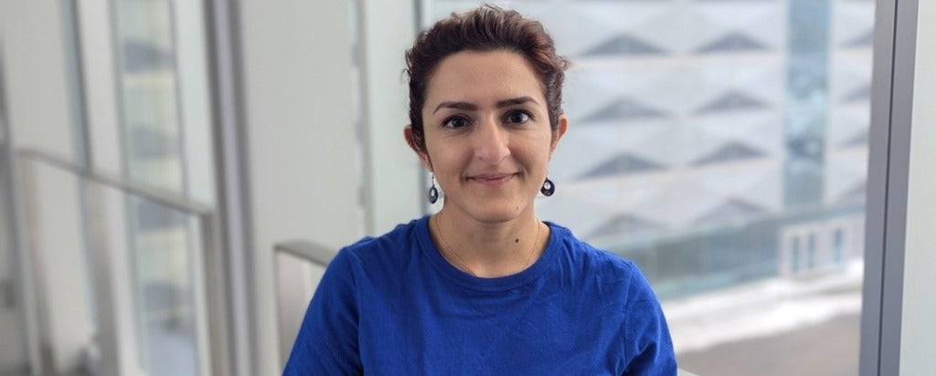 a woman in a blue t-shirt smiling