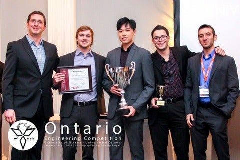 A judge for the 2018 Ontario Engineering Competition’s Innovative Design category congratulates Waterloo chemical engineering st