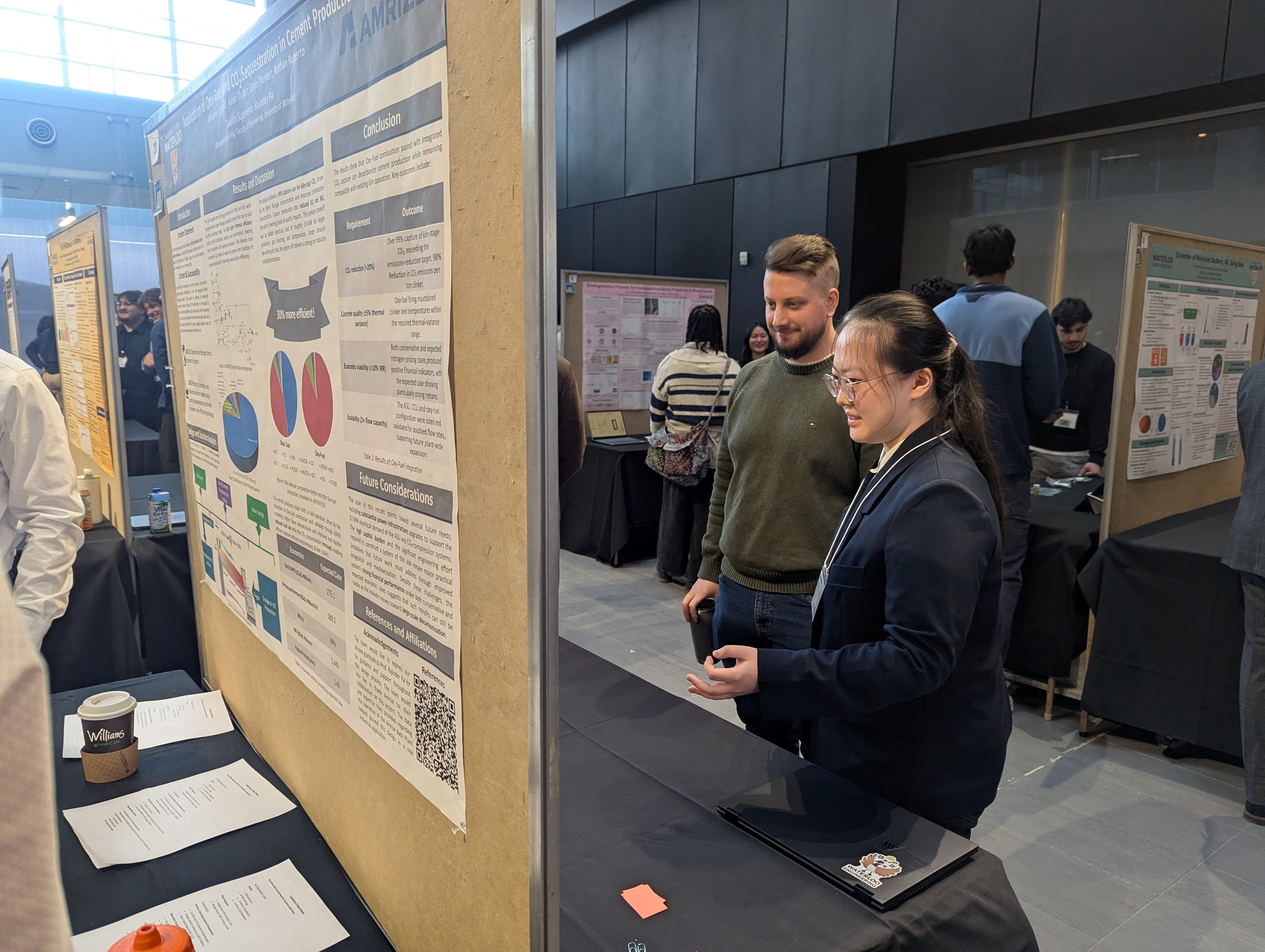a man and woman looking at a poster board