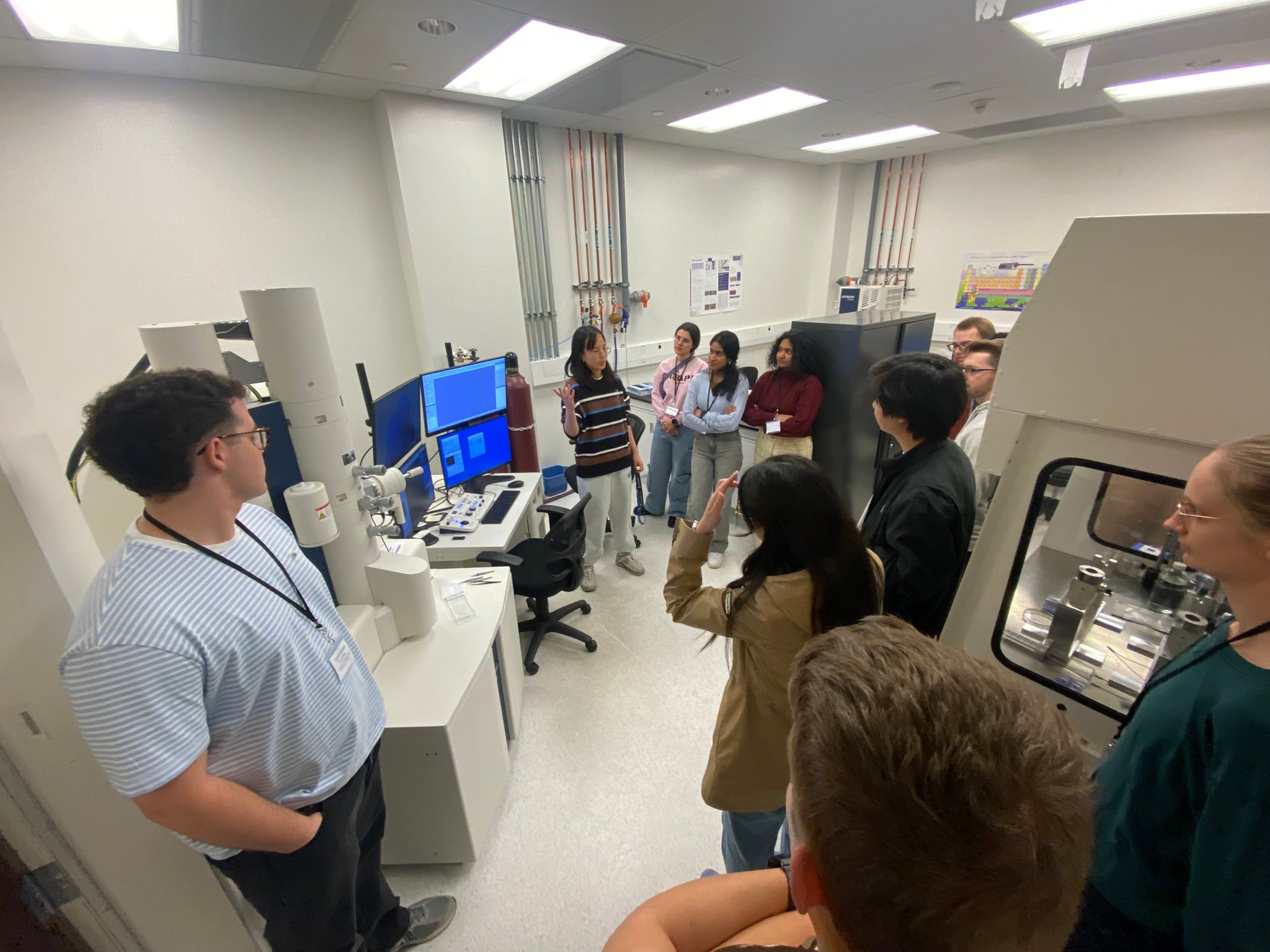 People looking at equipment in front of a monitor