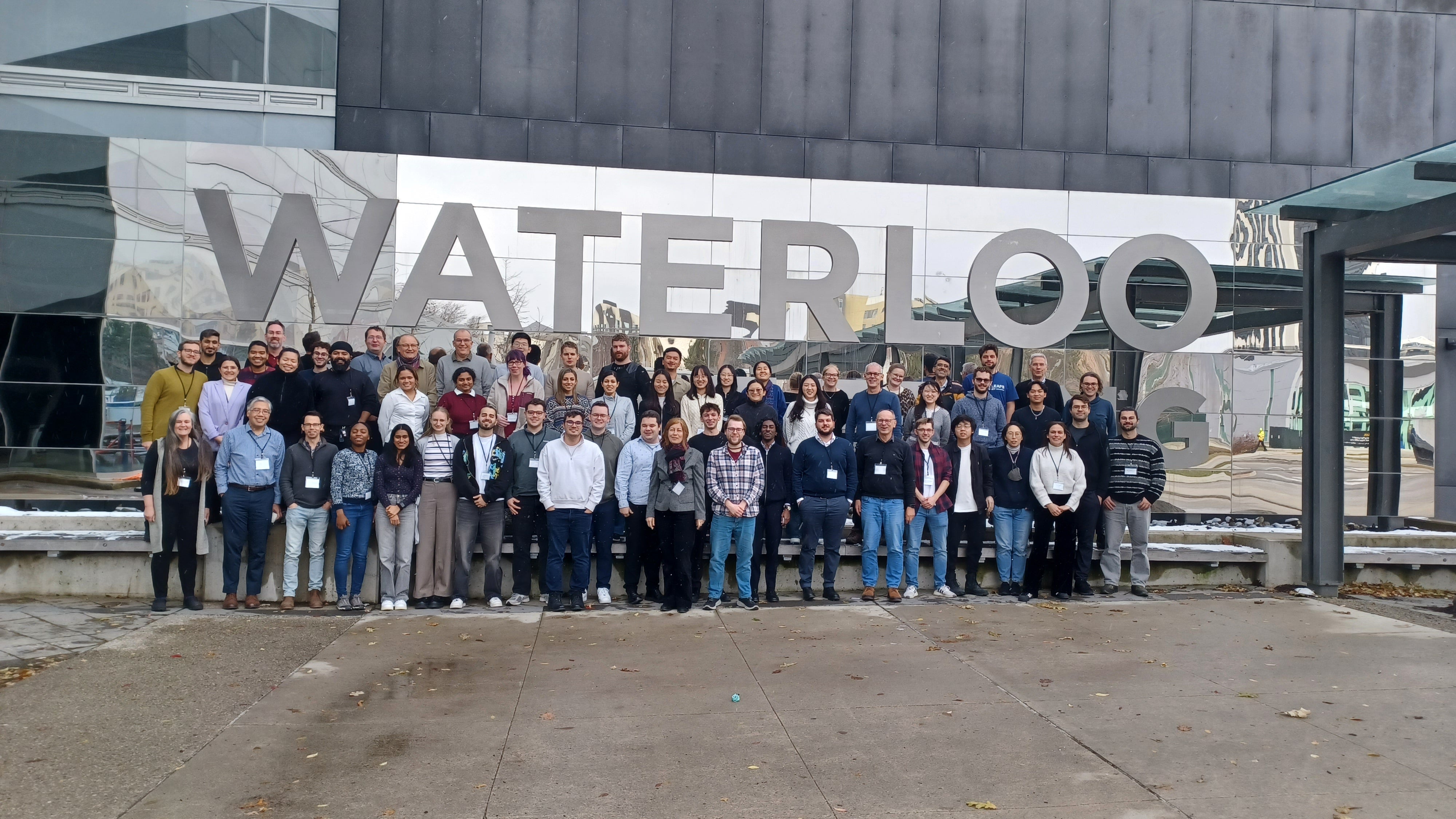 a large group of people in front of a Waterloo sign