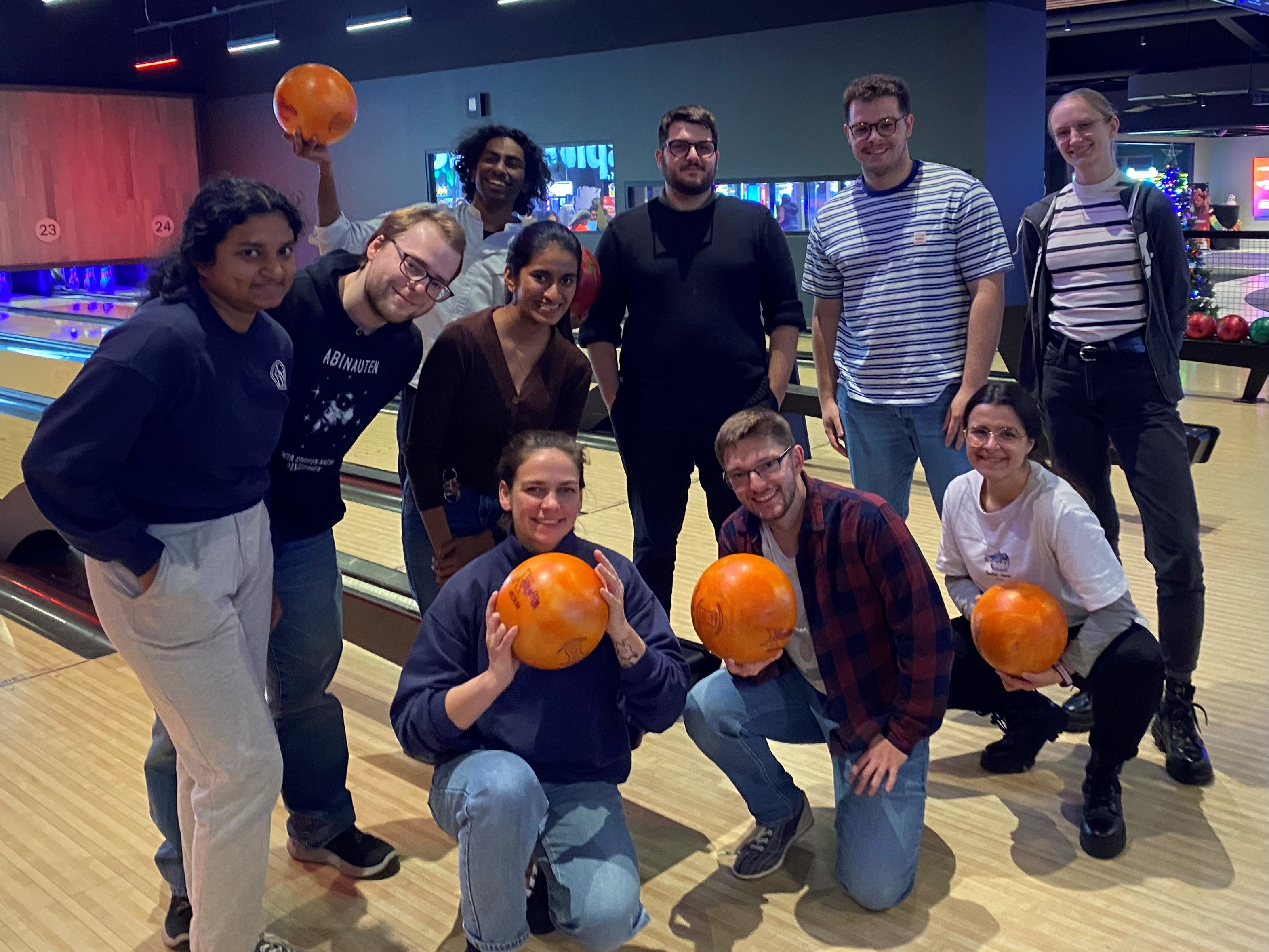 people posing with bowling balls