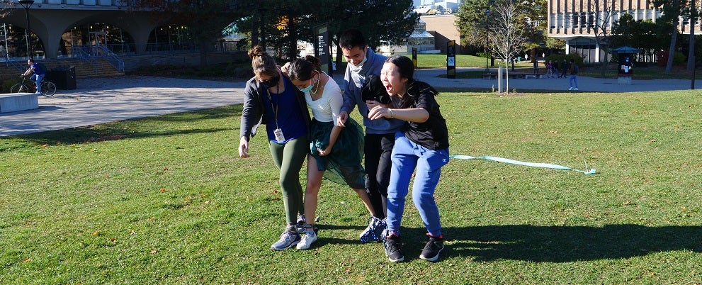 Four second year students racing with their legs tied together