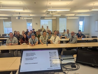 a group of people sitting in a classroom