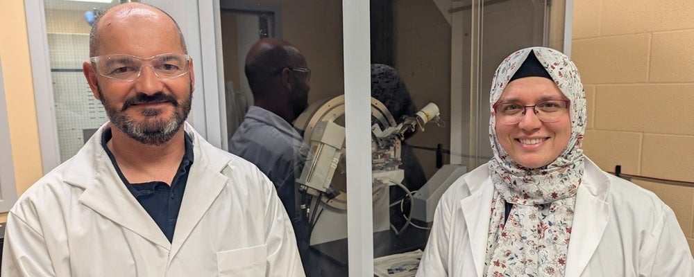 a man and woman in lab coats smiling