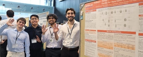 four men standing beside a poster board