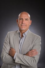 a man in a suit with his arms crossed