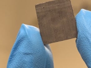 blue gloves holding a rectangular electrode