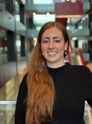 a woman with long red hair smiling
