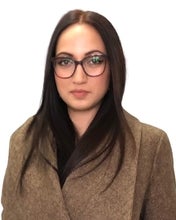 a woman with long black hair and glasses